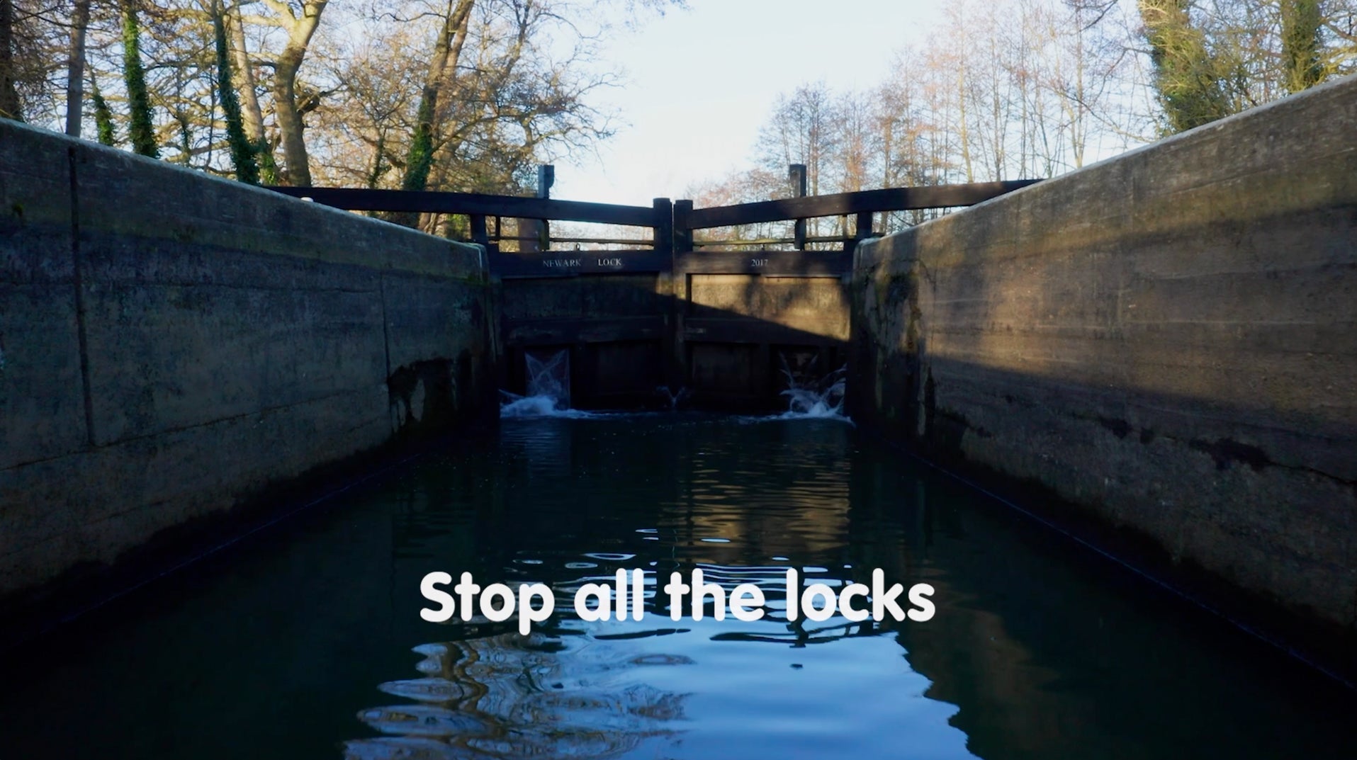 An image of a lock from within the waterway, with the text "Stop all the locks" overlaid